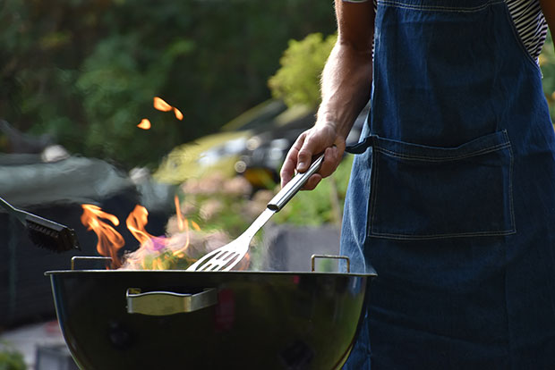 Man Using A Barbeque